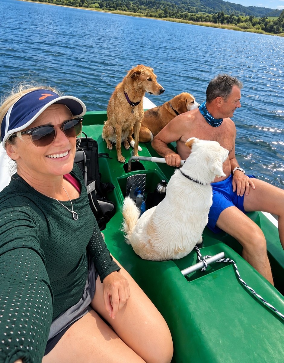 Couple and their three dogs enjoying a pedal boat on Swartvlei Lake